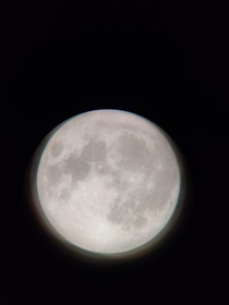 I took this picture on my phone using a telescope at full moon on Friday th