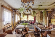 Inside the dining hall of an abandoned hotel  Photographed by Timeless Seeker