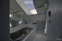 Jacuzzi Tub Under a Skylight in a Decaying Abandoned Mansion 