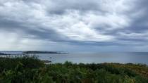 Light rain clouds over the English channel cape Frhel in the background Dinard  OC