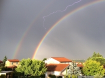 Lightning stuck between two rainbows Lyon France