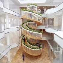Living Staircase a living spiral staircase with open spaces for reading drawing relaxing and drinking tea forming the centrepiece of a newly created workspace in Soho London United Kingdom 