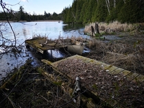 Long forgotten dock with boat still hooked up in Ontario