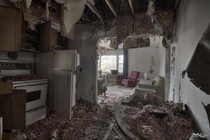 Looking Through the Kitchen into the Living Room of a Decayed Abandoned House 