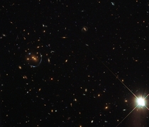 LRG-- and a gravitational lens of an even more distant galaxy LRG is the acronym given to a catalog of Luminous Red Galaxies found in the Sloan Digital Sky Survey SDSS These are mostly really massive elliptical galaxies full of huge numbers of old stars  