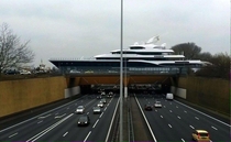 Mega-yacht crossing an aqueduct over a highway 
