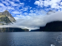 Milford Sound New Zealand with low hanging clouds 