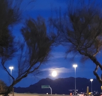 Moon looks huge coming up over the mountains in Phoenix Arizona USA