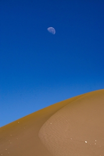 Moon over dune San Pedro de Atacama Chile 