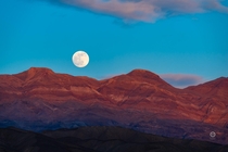 Moonrise over the badlands of Death Valley CA 