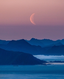 Moonrise over the distant peaks of Lofoten 