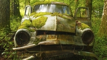 Moss covered car in Dordogne France 