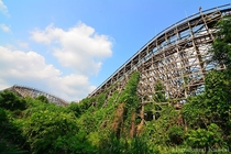 Mostly overgrown wooden rollercoaster Aska at the abandoned Nara Dreamland 