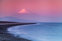 Mount Fuji in a pink haze at sunset I love the minimal style of this photo  photo by Jormungand