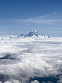 Mount Rainier peeking through the clouds Taken from my plane seat over Seattle Washington 