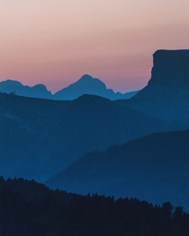 Mountain layers and pink skies before sunrise in the Dolomites 