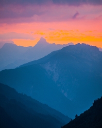 Mountain layers beneath a rosey sky Zrs Switzerland  by hansiphoto