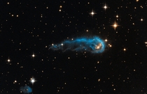 NASAs Hubble Sees a Cosmic Caterpillar - This light-year-long knot of interstellar gas and dust resembles a caterpillar on its way to a feast 