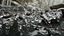 Natural ice sculpture above a mountain stream 