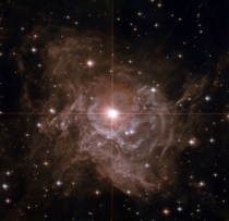 Nearby Cepheid Variable RS Pup -- It is one of the most important stars in the sky It is surrounded by a dazzling reflection nebula The brightest star in the image center is some ten times more massive than our Sun and on average  times more luminous 