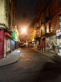 Nighttime view of old windy street in NYC Chinatown