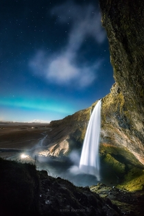 Northern Lights sprinkle the sky over Seljalandsfoss Iceland 