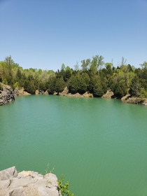 OC A stone quarry hidden deep within the back roads of Kentucky USA The water is so clear but at over ft deep youll never see the bottom x
