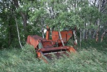 Old abandoned combine reclaimed by nature in my dads pasture 