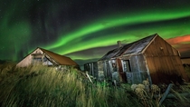 Old boat houses in Iceland under Northern Lights 