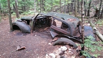Old car in the forest Killarney Provincial Park Ontario Canada