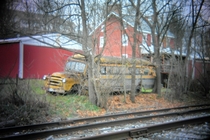 Old school bus in the backyard next to the train tracks Holga lens Southern PA 