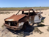 Old ute left on mud flats used to be a government vehicle