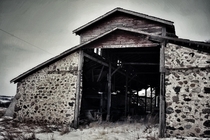 Olde Stone Barn with roof and walls falling in Southern Saskatchewan
