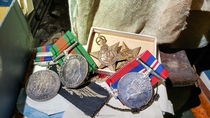 On this day in  I discovered these WW medals and Nazi war souvenirs in an abandoned house OC x