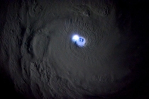 One of the most extraordinary surreal meteorological images ever Taken by astronaut Sam Cristoforetti a lightning within an intense thunderstorm in the eyewall of the storm lit up the eye of Tropical Cyclone Bansi 
