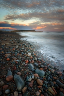 Pastel Pebbles dot the beach at Lawrencetown Beach Nova Scotia Canada 