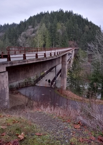 Pedestrianbicycle bridge suspended from under the motor vehicle bridge Olympic Discovery Trail over the Elwah River Washington State USA