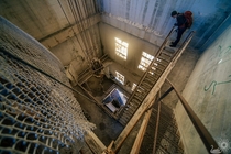 Peering down the stairs to an Abandoned  story concrete mill Near Bellingham WA 