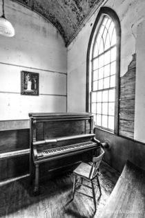 Piano and window in an abandoned church on the Niagara Peninsula in Ontario Canada