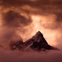 Pyramid Peak enveloped by clouds at sunset Southern Alps NZ  OC
