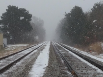 Railroad tracks on a foggy snowy day  Michigan 