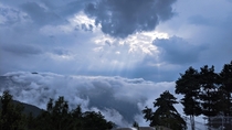Rays of early morning sun breaking through clouds over the hills of Murree Pakistan