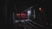 red lights on subway tunnel tracks 