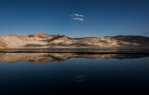 Reflection of the white sand hills over Sand Lake on the Pamir Plateau China 