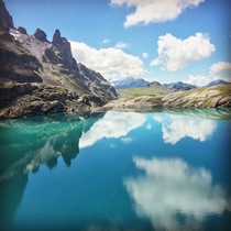 Reflections over the Schottensee an alpine lake in the Swiss Alps 