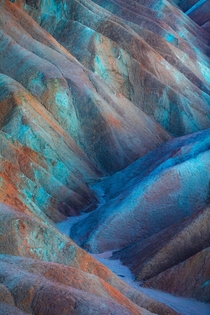 Rich mineral presence colors the hills at Zabriskie Point in Death Valley National Park an otherworldly rainbow