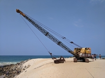 Rusty mobile crane on a beach in Brazil 
