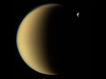 Saturns moon Tethys disappears behind Titan as observed by Cassini on Nov   Credit NASAJPL-CaltechSpace Science Institute