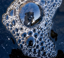 Self portrait shot in the reflection of bubbles flowing in a stream 