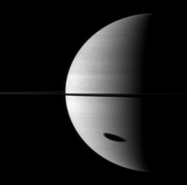 Shadow of satellite Titan approaching the terminator at Saturn Image in near infrared  nm was taken  km away from the gas giant by Cassini space probes wide angle camera on -- credit NASAJPLSpace Science Institute